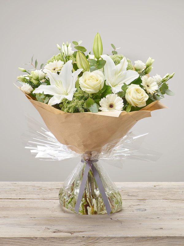 ‘White Radiance’ fresh flower arrangement. Includes ivory large headed roses, white germini, white ammi, white oriental lilies and white lisianthus.