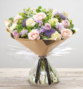 ‘Dusky Mauve’ hand created floral bouquet featuring cream carnations, pale pink large headed roses, lilac large headed roses, lilac freesia, lilac trachelium and bupleurum. (Code: L20921MS)