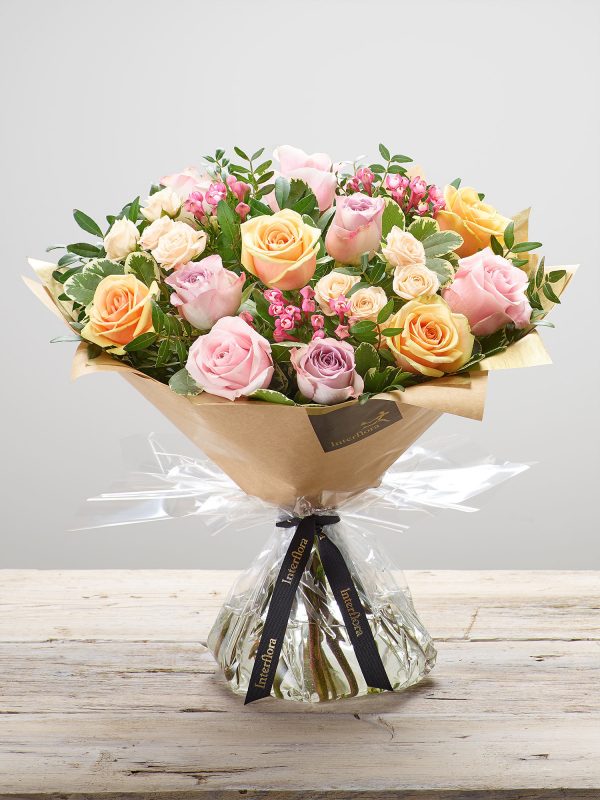 ‘Darling Rose’ hand-tied, fresh flower arrangement available for next day delivery. Featuring pink, peach and lilac large headed roses, cerise bouvardia and cream spray roses, hand-tied with pistache and pittosporum. (Code: L21151MS)