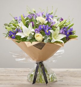 ‘Violet Vibes’ exquisite large hand-tied flower bouquet. Featuring ivory large headed roses, purple freesia, blue iris, white LA lilies and purple lisianthus hand-tied with thlaspi, pistache and eucalyptus. (Code: C14350BS)