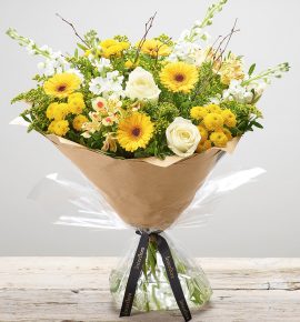 Large ‘Lemon Drizzle’ hand-tied flower arrangement - featuring white stocks, ivory large headed roses, yellow germini, yellow spray chrysanthemums, lemon alstroemeria and yellow solidago. (Code: S33242MS)